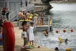Joyful Parisians take a historic plunge into the Seine after 100 years